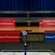 Signs sit behind the podium before the start of a press conference with New York’s then attorney general to announce a multistate lawsuit to block the Trump administration from adding a question about citizenship to the 2020 census form, April 3, 2018, in New York City.
